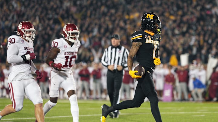 Nov 9, 2024; Columbia, Missouri, USA; Missouri Tigers wide receiver Theo Wease Jr. (1) scores a touchdown against Oklahoma Sooners defensive lineman Ethan Downs (40) and linebacker Kip Lewis (10) during the second half at Faurot Field at Memorial Stadium. Mandatory Credit: Jay Biggerstaff-Imagn Images