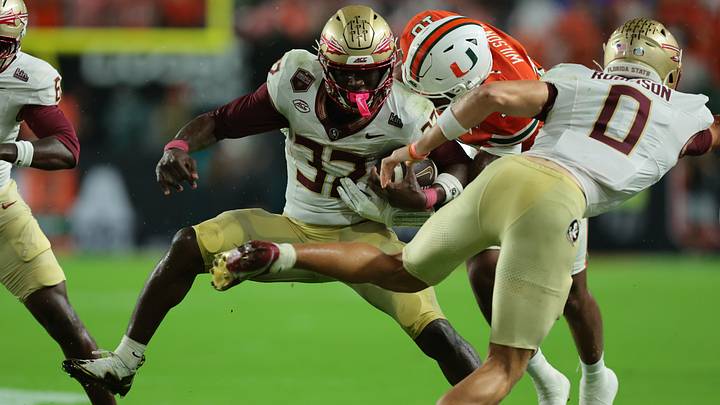 Oct 17, 2026; Miami Gardens, Florida, USA; Florida State Seminoles running back Ousmane Kromah (32) runs against Miami Hurricanes defensive line Damon Wilson II (10) during the first quarter at Hard Rock Stadium. Mandatory Credit: Sam Navarro-Imagn Images Oct 17, 2026; Miami Gardens, Florida, USA; Florida State Seminoles running back Ousmane Kromah (32) runs against Miami Hurricanes defensive line Damon Wilson II (10) during the first quarter at Hard Rock Stadium. Mandatory Credit: Sam Navarro-Imagn Images
