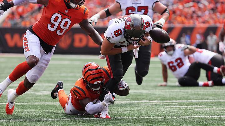 Sep 13, 2026; Cincinnati, Ohio, USA;  Cincinnati Bengals linebacker Barrett Carter (49) attempts to tackle Tampa Bay Buccaneers quarterback Baker Mayfield (6) during the second quarter at Paycor Stadium.  Mandatory Credit: Joseph Maiorana-Imagn Images