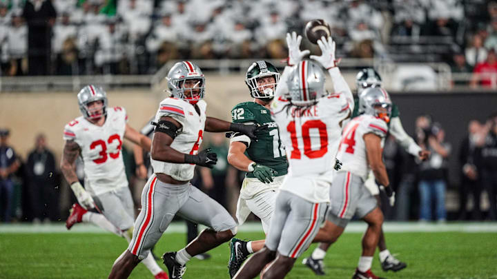 Ohio State Buckeyes cornerback Denzel Burke intercepts a pass from Michigan State Spartans quarterback Aidan Chiles as tight end Jack Velling looks on during the third quarter at Spartan Stadium in East Lansing, Saturday, Sept. 28, 2024.