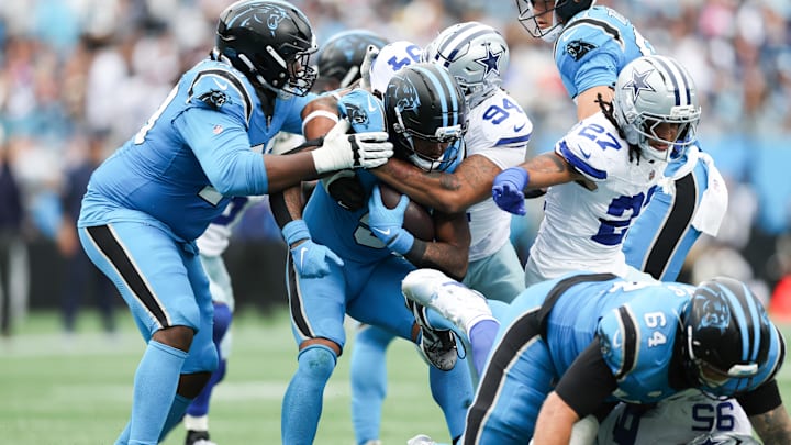 Oct 12, 2025; Charlotte, North Carolina, USA; Dallas Cowboys punter Bryan Anger (5) is tackled by Dallas Cowboys defensive end Marshawn Kneeland (94) during the second half at Bank of America Stadium. Mandatory Credit: Cory Knowlton-Imagn Images Oct 12, 2025; Charlotte, North Carolina, USA; Dallas Cowboys punter Bryan Anger (5) is tackled by Dallas Cowboys defensive end Marshawn Kneeland (94) during the second half at Bank of America Stadium. Mandatory Credit: Cory Knowlton-Imagn Images