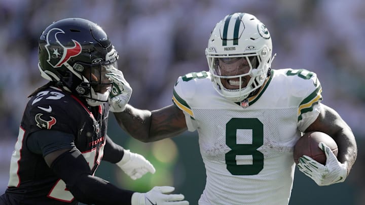Green Bay Packers running back Josh Jacobs (8) stiff-arms Houston Texans safety Eric Murray (23) during the third quarter of their game Sunday, October 20, 2024 at Lambeau Field in Green Bay, Wisconsin.