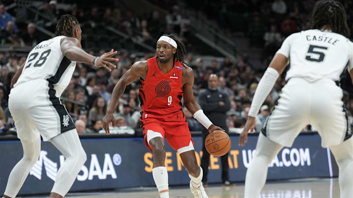 Dec 21, 2024; San Antonio, Texas, USA;  Portland Trail Blazers forward Jerami Grant (9) dribbles the ball against San Antonio Spurs center Charles Bassey (28) and guard Stephon Castle (5) in the first half at Frost Bank Center. Mandatory Credit: Daniel Dunn-Imagn Images
