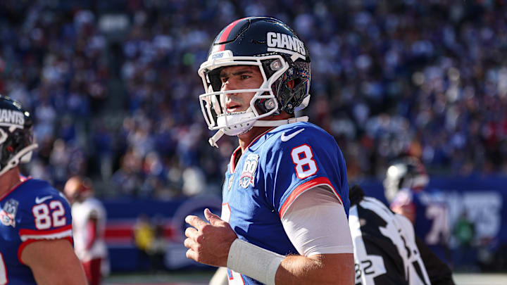 Nov 3, 2024; East Rutherford, New Jersey, USA; New York Giants quarterback Daniel Jones (8) runs off the field after throwing a touchdown pass during the first half against the Washington Commanders at MetLife Stadium.  
