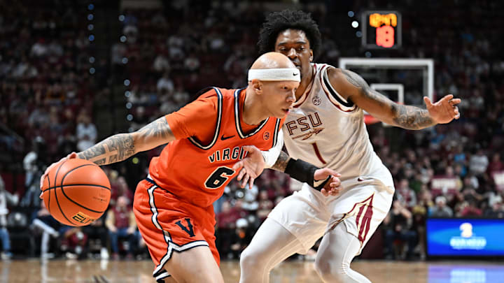 Feb 10, 2026; Tallahassee, Florida, USA; Virginia Cavaliers guard Jacari White (6) dribbles past Florida State Seminoles guard Martin Somerville (1) during the first half at Donald L. Tucker Center. Mandatory Credit: Melina Myers-Imagn Images