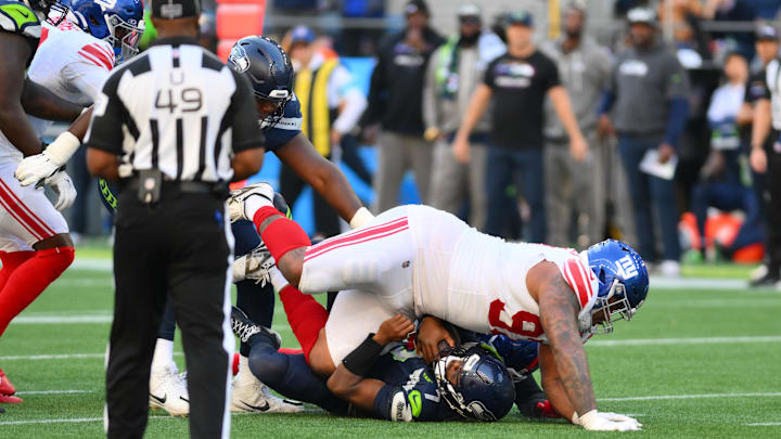 Oct 6, 2024; Seattle, Washington, USA; New York Giants defensive tackle Dexter Lawrence II (97) sacks Seattle Seahawks quarterback Geno Smith (7) during the second half at Lumen Field. Oct 6, 2024; Seattle, Washington, USA; New York Giants defensive tackle Dexter Lawrence II (97) sacks Seattle Seahawks quarterback Geno Smith (7) during the second half at Lumen Field.