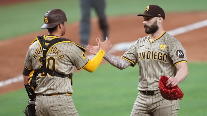 Aug 10, 2024; Miami, Florida, USA; San Diego Padres catcher Kyle Higashioka (20) congratulates pitcher Trevor Scott (61) on a victory against the Miami Marlins at loanDepot Park. Mandatory Credit: Jim Rassol-Imagn Images Aug 10, 2024; Miami, Florida, USA; San Diego Padres catcher Kyle Higashioka (20) congratulates pitcher Trevor Scott (61) on a victory against the Miami Marlins at loanDepot Park. Mandatory Credit: Jim Rassol-Imagn Images