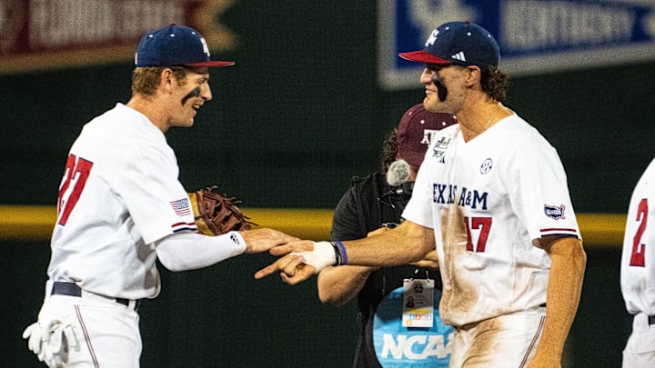 Jun 15, 2024; Omaha, NE, USA; Texas A&M Aggies first baseman Ted Burton (27) and right fielder Jace Laviolette (17) celebrate after defeating the Florida Gators at Charles Schwab Field Omaha. Mandatory Credit: Dylan Widger-Imagn Images