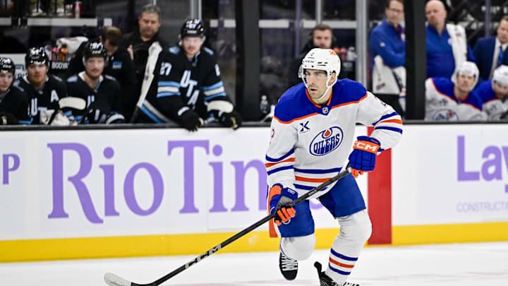 Nov 29, 2024; Salt Lake City, Utah, USA; Edmonton Oilers defenseman Evan Bouchard (2) moves the puck down the ice against the Utah Hockey Club during the third period at the Delta Center. Mandatory Credit: Christopher Creveling-Imagn Images