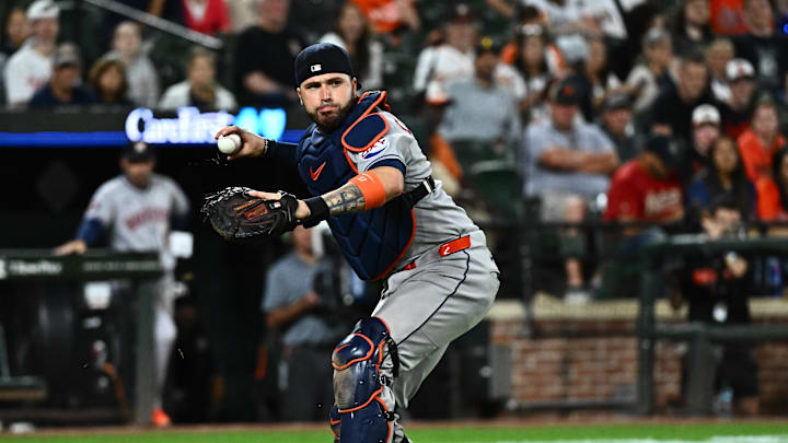 Aug 21, 2025; Baltimore, Maryland, USA;  Houston Astros catcher Victor Caratini (17) throws to first base during the seventh inning against the Baltimore Orioles at Oriole Park at Camden Yards. 