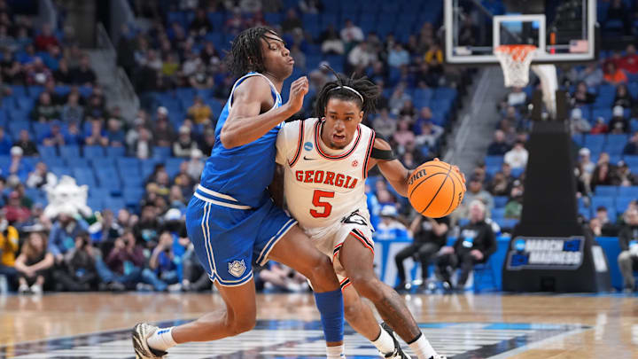Mar 19, 2026; Buffalo, NY, USA; Georgia Bulldogs guard Jeremiah Wilkinson (5) dribbles the ball against Saint Louis Billikens guard Quentin Jones (1) during the second half of a first round game of the men's 2026 NCAA Tournament at Keybank Center. Mandatory Credit: Gregory Fisher-Imagn Images