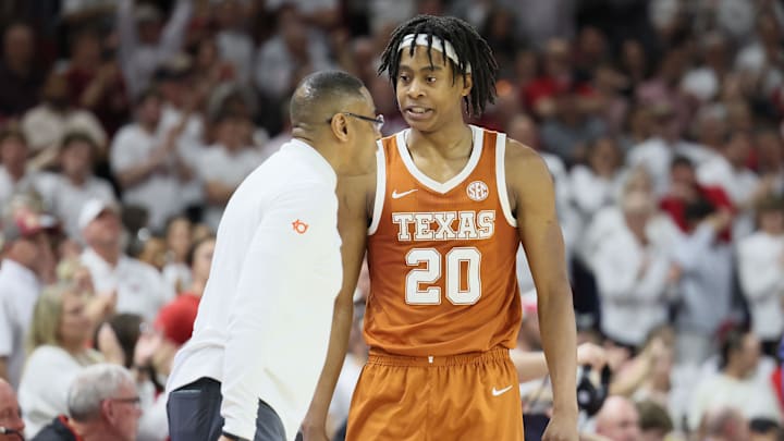 Feb 26, 2025; Fayetteville, Arkansas, USA; Texas Longhorns guard Tre Johnson (20) talks to head coach Rodney Terry during overtime against the Arkansas Razorbacks at Bud Walton Arena. Mandatory Credit: Nelson Chenault-Imagn Images
