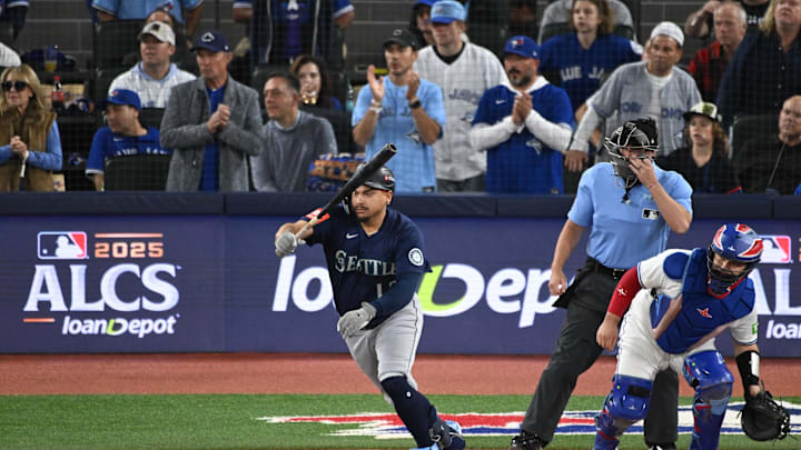 Oct 20, 2025; Toronto, Ontario, CAN; Seattle Mariners first baseman Josh Naylor (12) hits an RBI single against the Toronto Blue Jays in the first inning during game seven of the ALCS round for the 2025 MLB playoffs at Rogers Centre. Mandatory Credit: Dan Hamilton-Imagn Images Oct 20, 2025; Toronto, Ontario, CAN; Seattle Mariners first baseman Josh Naylor (12) hits an RBI single against the Toronto Blue Jays in the first inning during game seven of the ALCS round for the 2025 MLB playoffs at Rogers Centre. Mandatory Credit: Dan Hamilton-Imagn Images