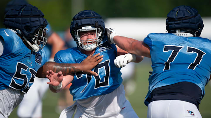 Tennessee Titans guard takes on tackle JC Latham (55) and offensive lineman Peter Skoronski (77) during training camp at Ascension Saint Thomas Sports Park in Nashville, Tenn., Saturday, Aug. 3, 2024.