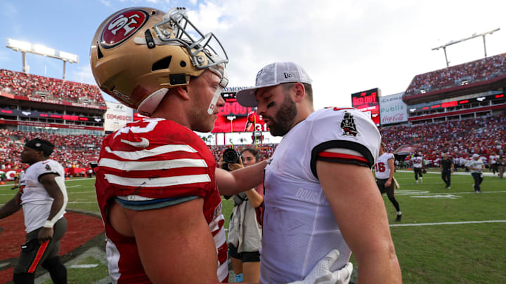 Nov 10, 2024; Tampa, Florida, USA; San Francisco 49ers running back Christian McCaffrey (23) greets Tampa Bay Buccaneers quarterback Baker Mayfield (6) after a game at Raymond James Stadium. Mandatory Credit: Nathan Ray Seebeck-Imagn Images