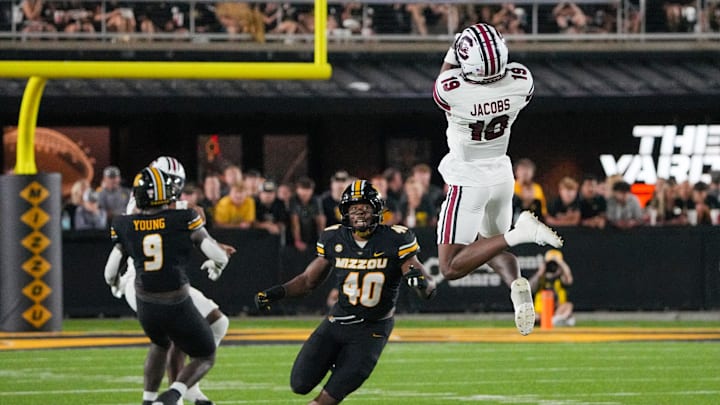 Sep 20, 2025; Columbia, Missouri, USA; South Carolina Gamecocks wide receiver Vandrevius Jacobs (19) makes a leaping catch as Missouri Tigers linebacker Josiah Trotter (40) defends during the second half of the game at Faurot Field at Memorial Stadium. Mandatory Credit: Denny Medley-Imagn Images Sep 20, 2025; Columbia, Missouri, USA; South Carolina Gamecocks wide receiver Vandrevius Jacobs (19) makes a leaping catch as Missouri Tigers linebacker Josiah Trotter (40) defends during the second half of the game at Faurot Field at Memorial Stadium. Mandatory Credit: Denny Medley-Imagn Images