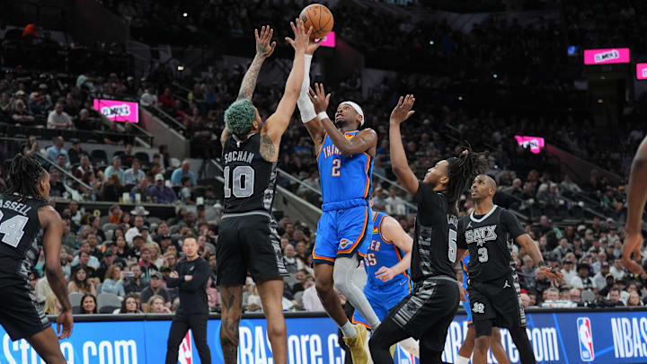 Mar 2, 2025; San Antonio, Texas, USA; Oklahoma City Thunder guard Shai Gilgeous-Alexander (2) shoots between San Antonio Spurs forward Jeremy Sochan (10) and guard Stephon Castle (5) in the second half at Frost Bank Center. Mandatory Credit: Daniel Dunn-Imagn Images Mar 2, 2025; San Antonio, Texas, USA; Oklahoma City Thunder guard Shai Gilgeous-Alexander (2) shoots between San Antonio Spurs forward Jeremy Sochan (10) and guard Stephon Castle (5) in the second half at Frost Bank Center. Mandatory Credit: Daniel Dunn-Imagn Images