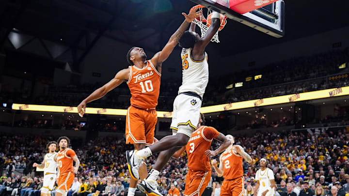 Feb 14, 2026; Columbia, Missouri, USA; Missouri Tigers forward Mark Mitchell (25) dunks the ball as Texas Longhorns forward Nic Codie (10) defends during the first half of the game at Mizzou Arena. Mandatory Credit: Denny Medley-Imagn Images