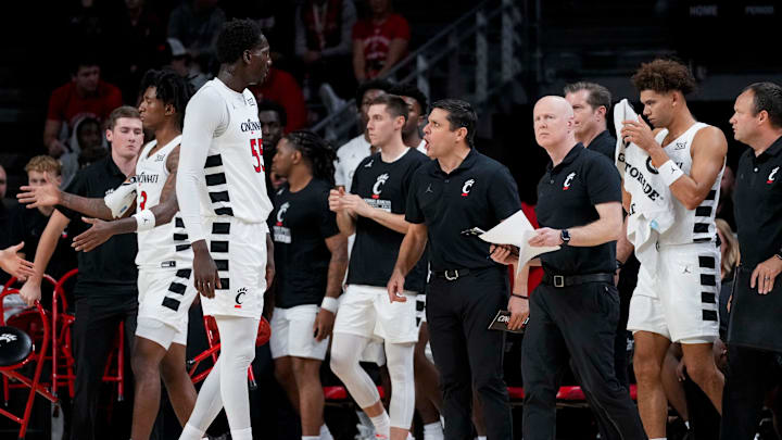 Nov 4, 2024; Cincinnati, OH, USA; Cincinnati Bearcats head coach Wes Miller shouts to forward Aziz Bandaogo (55) going into a timeout in the first half of the NCAA mens basketball game between the Cincinnati Bearcats and the Arkansas-Pine Bluff Golden Lions at Fifth Third Arena. Mandatory Credit: Sam Greene/USA TODAY Network via Imagn Images Nov 4, 2024; Cincinnati, OH, USA; Cincinnati Bearcats head coach Wes Miller shouts to forward Aziz Bandaogo (55) going into a timeout in the first half of the NCAA mens basketball game between the Cincinnati Bearcats and the Arkansas-Pine Bluff Golden Lions at Fifth Third Arena. Mandatory Credit: Sam Greene/USA TODAY Network via Imagn Images