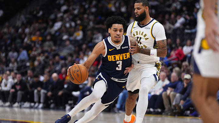 Nov 8, 2025; Denver, Colorado, USA; Indiana Pacers guard Andrew Nembhard (2) defends on Denver Nuggets guard Julian Strawther (3) in the second half at Ball Arena. Mandatory Credit: Ron Chenoy-Imagn Images