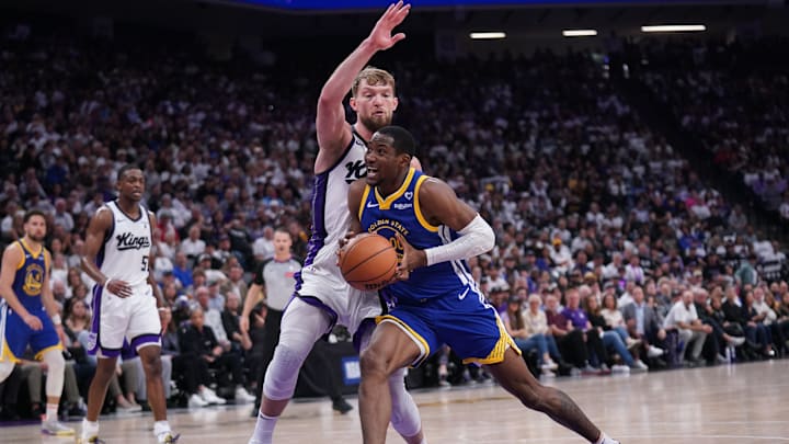Apr 16, 2024; Sacramento, California, USA; Golden State Warriors forward Jonathan Kuminga (00) drives to the hoop next to Sacramento Kings forward Domantas Sabonis (10) in the second quarter during a play-in game of the 2024 NBA playoffs at the Golden 1 Center. Mandatory Credit: Cary Edmondson-Imagn Images
