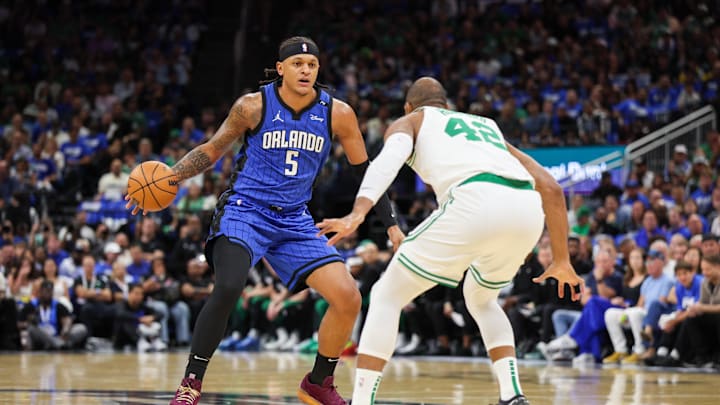 Apr 27, 2025; Orlando, Florida, USA; Orlando Magic forward Paolo Banchero (5) controls the ball from Boston Celtics center Al Horford (42) in the first quarter during game four of first round for the 2025 NBA Playoffs at Kia Center. Mandatory Credit: Nathan Ray Seebeck-Imagn Images