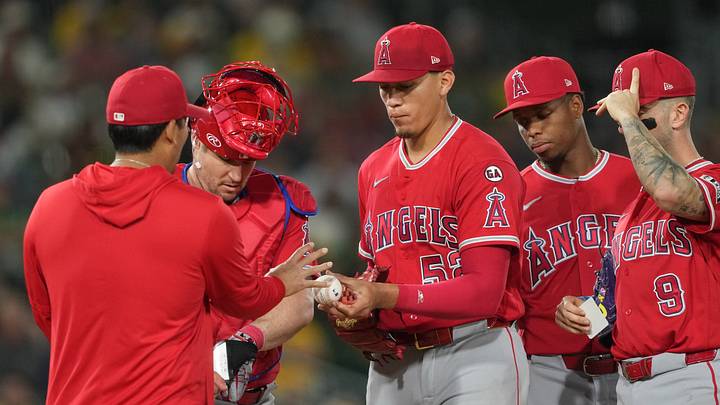 Los Angeles Angels pitcher Samy Natera Jr. (center) hands the game ball to manager Kurt Suzuki (left) during the seventh inning against the Athletics at Sutter Health Park on June 20. Los Angeles Angels pitcher Samy Natera Jr. (center) hands the game ball to manager Kurt Suzuki (left) during the seventh inning against the Athletics at Sutter Health Park on June 20.