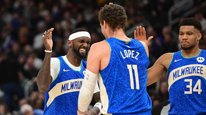 Feb 12, 2024; Milwaukee, Wisconsin, USA; Milwaukee Bucks forward Bobby Portis (9), center Brook Lopez (11 and forward Giannis Antetokounmpo (34) celebrate after a score in the fourth quarter against the Denver Nuggets at Fiserv Forum. Mandatory Credit: Benny Sieu-Imagn Images