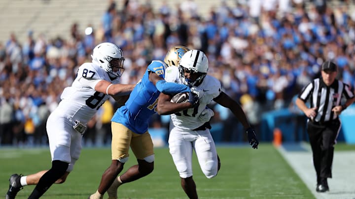 Penn State Nittany Lions running back Nicholas Singleton (10) is tackled by UCLA Bruins defensive back Rodrick Pleasant (18) during the fourth quarter at Rose Bowl. Mandatory Credit: Kiyoshi Mio-Imagn Images