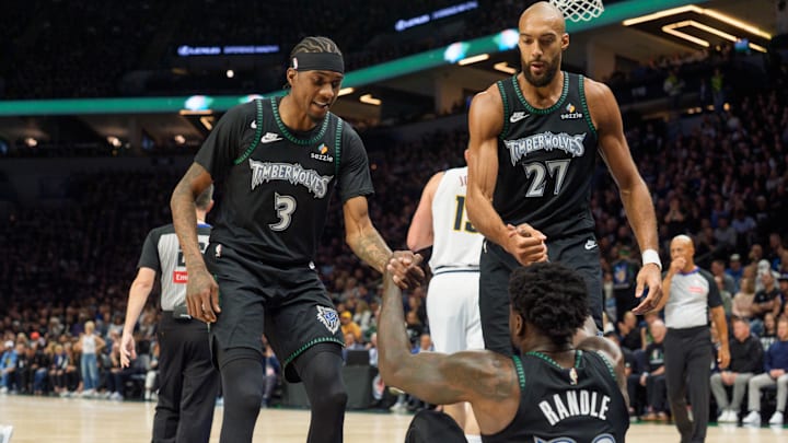 Apr 25, 2026; Minneapolis, Minnesota, USA; Minnesota Timberwolves center Rudy Gobert (27) and forward Jaden McDaniels (3) help up forward Julius Randle (30) after a foul by the Denver Nuggets in the first quarter at Target Center. Mandatory Credit: Matt Blewett-Imagn Images