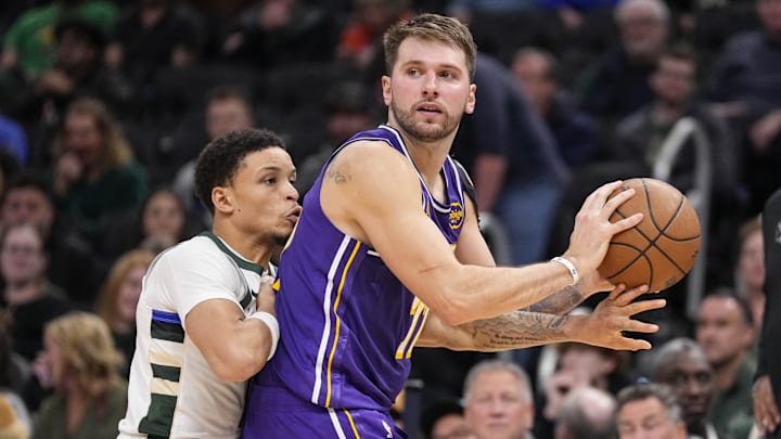 Nov 15, 2025; Milwaukee, Wisconsin, USA; Los Angeles Lakers guard Luka Doncic (77) looks to pass the ball as Milwaukee Bucks guard Ryan Rollins (13) defends during the fourth quarter at Fiserv Forum. Mandatory Credit: Jeff Hanisch-Imagn Images Nov 15, 2025; Milwaukee, Wisconsin, USA; Los Angeles Lakers guard Luka Doncic (77) looks to pass the ball as Milwaukee Bucks guard Ryan Rollins (13) defends during the fourth quarter at Fiserv Forum. Mandatory Credit: Jeff Hanisch-Imagn Images