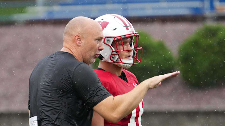 Wisconsin football assistant defensive backs coach Scott Power talks with safety Grant Dean (16) during practice, July 30, 2025, at Ralph E. Davis Pioneer Stadium in Platteville, Wisconsin.
