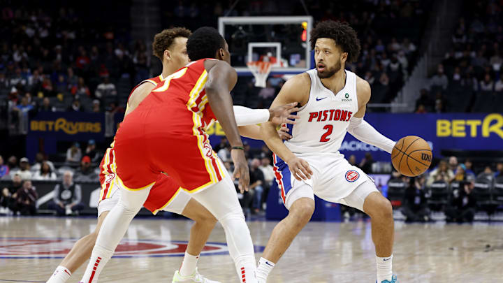 Feb 3, 2025; Detroit, Michigan, USA;  Detroit Pistons guard Cade Cunningham (2) dribbles defended by Atlanta Hawks forward Onyeka Okongwu (17) in the first half at Little Caesars Arena. Mandatory Credit: Rick Osentoski-Imagn Images