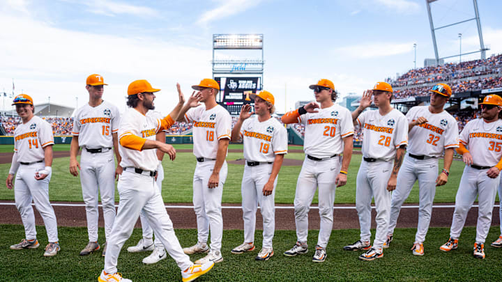 Jun 22, 2024; Omaha, NE, USA; Tennessee Volunteers head coach Tony Vitello high fives players before a game against the Texas A&M Aggies at Charles Schwab Field Omaha. Mandatory Credit: Dylan Widger-Imagn Images