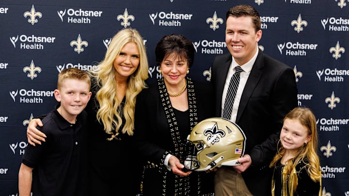 Feb 13, 2025; New Orleans, LA, USA; New Orleans Saints owner Gayle Benson poses with head coach Kellen Moore and wife Jill Wilson and family at Ochsner Sports Performance Center. Mandatory Credit: Stephen Lew-Imagn Images Feb 13, 2025; New Orleans, LA, USA; New Orleans Saints owner Gayle Benson poses with head coach Kellen Moore and wife Jill Wilson and family at Ochsner Sports Performance Center. Mandatory Credit: Stephen Lew-Imagn Images
