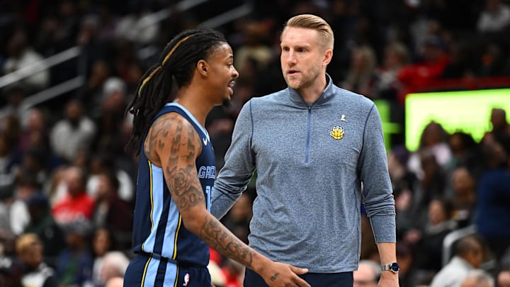 Dec 28, 2025; Washington, District of Columbia, USA; Memphis Grizzlies head coach Tuomas Iisalo talks with guard Ja Morant (12) against the Washington Wizards during the first half at Capital One Arena. Mandatory Credit: Brad Mills-Imagn Images