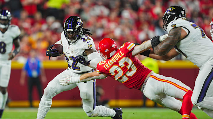 Sep 5, 2024; Kansas City, Missouri, USA; Baltimore Ravens running back Derrick Henry (22) runs the ball against Kansas City Chiefs linebacker Drue Tranquill (23) during the first half at GEHA Field at Arrowhead Stadium. Mandatory Credit: Jay Biggerstaff-Imagn Images