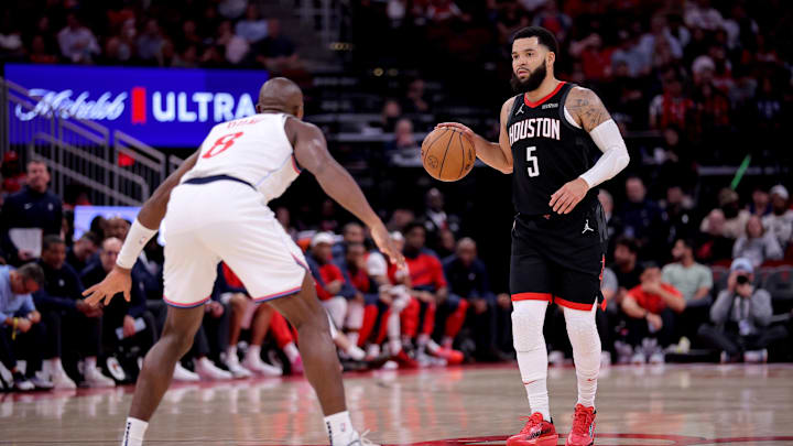 Nov 13, 2024; Houston, Texas, USA; Houston Rockets guard Fred VanVleet (5) handles the ball against LA Clippers guard Kris Dunn (8) during the third quarter at Toyota Center. Mandatory Credit: Erik Williams-Imagn Images