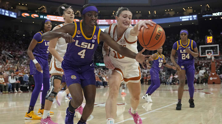 Feb 16, 2025; Austin, Texas, USA; Louisiana State Lady Tigers guard Flau'jae Johnson (4) and Texas Longhorns guard Shay Holle (10) battle for the loose ball during the first half at Moody Center. Mandatory Credit: Scott Wachter-Imagn Images