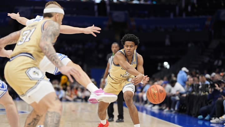 Mar 13, 2025; Charlotte, NC, USA;  Georgia Tech Yellow Jackets guard Jaeden Mustaf (3) passes off to forward Duncan Powell (31) against the Duke Blue Devils during the first half at Spectrum Center. Mandatory Credit: Jim Dedmon-Imagn Images