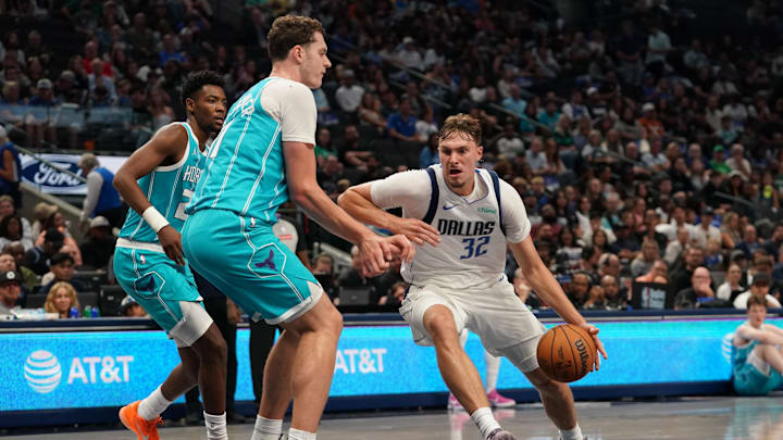 Oct 11, 2025; Dallas, TX; Dallas Mavericks forward Cooper Flagg drives around Charlotte Hornets center Ryan Kalkbrenner during a game at American Airlines Center