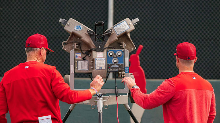 Feb 19, 2023; Tempe, AZ, USA; A general view as members of the coaching staff setup a pitching machine during a spring training workout for the Los Angeles Angels at Tempe Diablo Stadium. Mandatory Credit: Allan Henry-Imagn Images Feb 19, 2023; Tempe, AZ, USA; A general view as members of the coaching staff setup a pitching machine during a spring training workout for the Los Angeles Angels at Tempe Diablo Stadium. Mandatory Credit: Allan Henry-Imagn Images