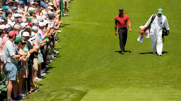 Apr 14, 2024; Augusta, Georgia, USA; Tiger Woods and his caddie, Lance Bennett, walk to the No. 18