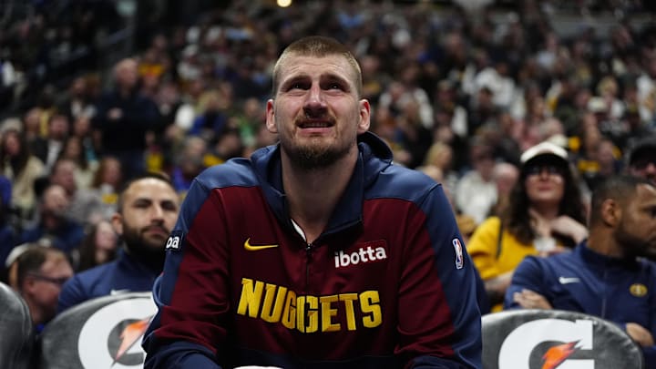 Jokic on the bench during a game. 