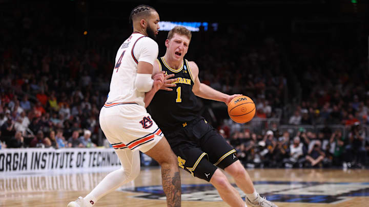 Mar 28, 2025; Atlanta, GA, USA; Michigan Wolverines center Danny Wolf (1) drives against Auburn Tigers forward Johni Broome (4) in the second half of a South Regional semifinal of the 2025 NCAA tournament at State Farm Arena. Mandatory Credit: Brett Davis-Imagn Images