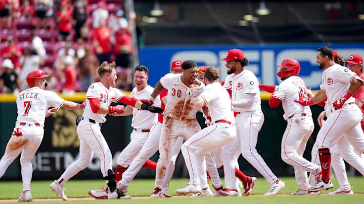 Cincinnati Reds outfielder Will Benson (30) is embraced by his teammates after hitting a RBI single that led to a 3-2 win against the San Diego Padres, Sunday, June 29, 2025, at Great American Ball Park in Downtown Cincinnati.