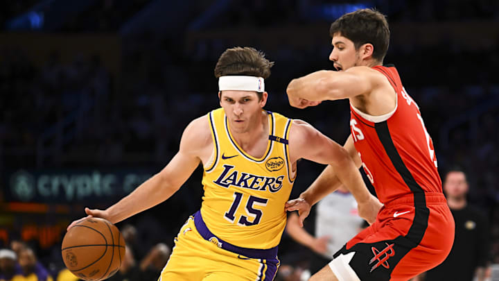 Apr 11, 2025; Los Angeles, California, USA; Los Angeles Lakers guard Austin Reaves (15) drives the ball against Houston Rockets guard Reed Sheppard (15) during the first half at Crypto.com Arena. Mandatory Credit: Jonathan Hui-Imagn Images