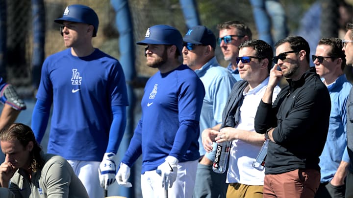 Dodgers first baseman Freddie Freeman (5), third baseman Max Muncy (13), president of baseball operations Andrew Friedman and executive vice president and general manager Brandon Gomes watch during batting practice at spring training at Camelback Ranch. Dodgers first baseman Freddie Freeman (5), third baseman Max Muncy (13), president of baseball operations Andrew Friedman and executive vice president and general manager Brandon Gomes watch during batting practice at spring training at Camelback Ranch.