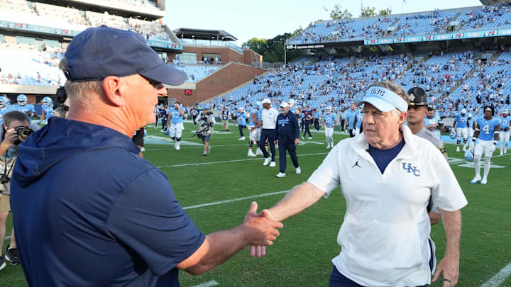 Sep 13, 2025; Chapel Hill, North Carolina, USA; Richmond Spiders head coach Russ Huesman with North Carolina Tar Heels head coach Bill Belichick after the game at Kenan Stadium. 