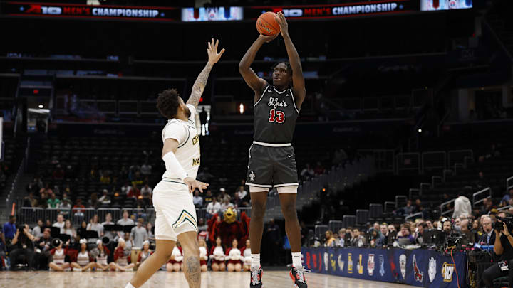 Saint Joseph's Hawks forward Rasheer Fleming shoots the ball over forward Shawn Simmons II. Saint Joseph's Hawks forward Rasheer Fleming shoots the ball over forward Shawn Simmons II.